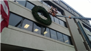 A large holiday wreath on the side of a public building