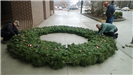A large holiday wreath lying on the ground