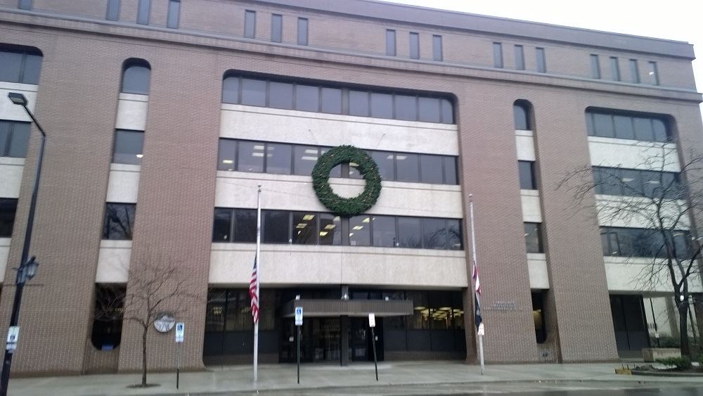 A large holiday wreath hanging on a public building 2